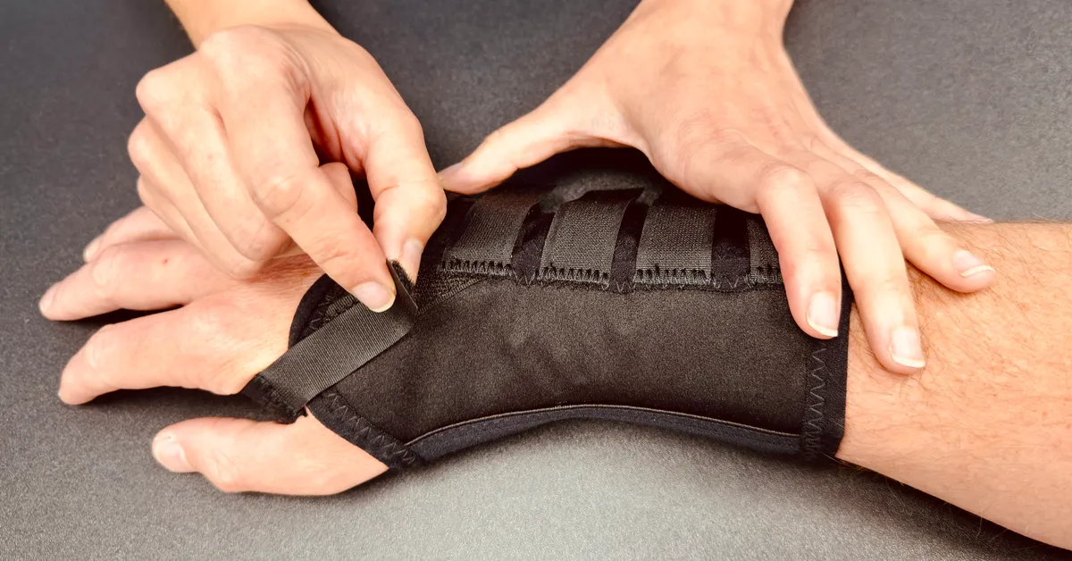 Consultant Hand Therapist Ms Razo fitting a wrist splint to a patient's wrist